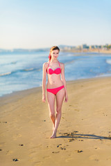 Beautiful young woman bikini pinup at beach