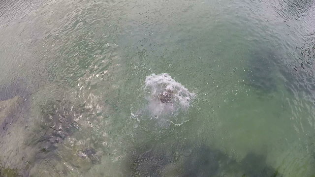 Little girl jumping into river