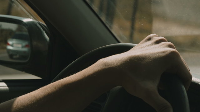 hand on the steering wheel in motion