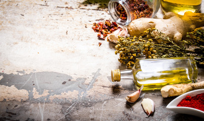 A set of dried spices and herbs with olive oil.