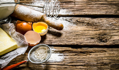Preparation of the dough. Ingredients for the dough - egg, flour, butter with a rolling pin .