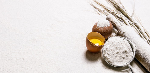 Eggs with venicom and rolling pin in flour.  Free space for text .