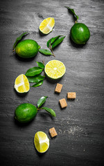 Lime background. Limes, sugar and leaves.