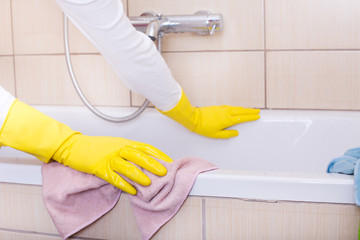 Woman cleaning bathtub