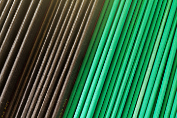 Stack of green and black text books on a library shelf