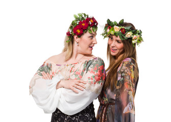 Beautiful girl and woman in wreath of flowers