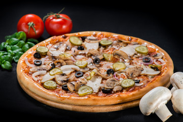 closeup Tasty pizza with tomatoes, mushroom, sausage, basil and