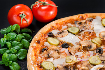 closeup Tasty pizza with tomatoes, mushroom, sausage, basil and