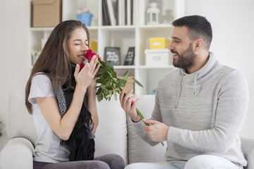 Young man gives a girl flowers for Valentine's Day, shallow depth of field