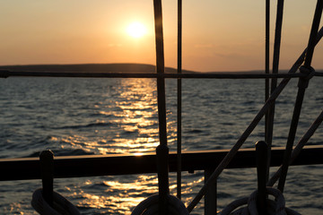 sailing vessel ropes against sunset