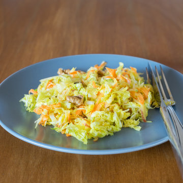 Savoy cabbage, brussels sprouts, apple, carrot and walnut salad on plate