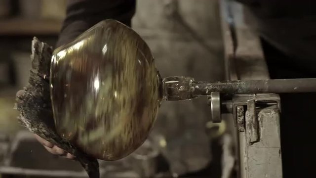 Glassblower forming molten glass
