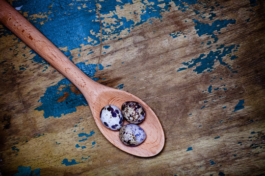 Composition with quail eggs. Wooden texture for background. Tone