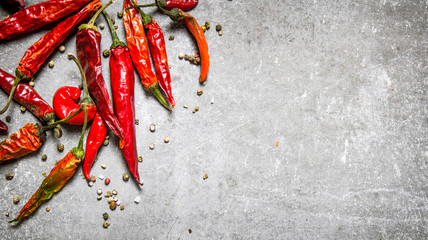 Red chili pepper dried. On stone background. - obrazy, fototapety, plakaty