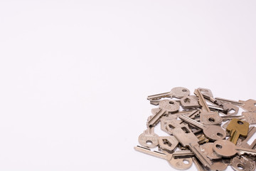 Old keys arranged on a white background