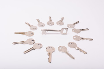 Old keys arranged on a white background