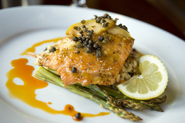Wild Salmon fillet with capers and pear reduction sauce over wild rice and asparagus.