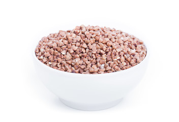 Dry buckwheat in white bowl