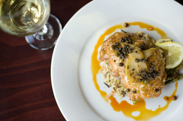 Wild Salmon fillet with capers in a pear reduction sauce over wild rice and asparagus, paired with...
