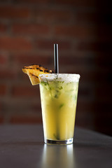 Pineapple mojito mixed drink cocktail with sugar and fresh pineapple garnish