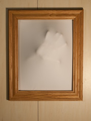 Creepy Picture Frame with Something Coming Out of It