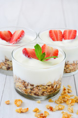 Yogurt glass with cereals and strawberries
