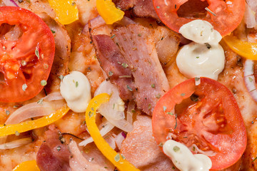 closeup Tasty pizza with tomatoes, cheese, basil and ham on a bl