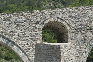 Fototapeta na wymiar Detail of the ancient Devil's Bridge near Ardino in Bulgaria...