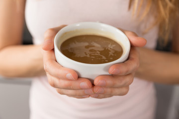 Female hands holding a cup of coffee