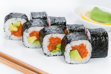 closeup roll sushi with chopsticks and ginger (shallow DOF)