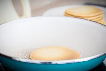 Making home made pancakes on frying pan