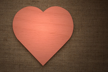Naklejka na ściany i meble red wooden heart on burlap fabric