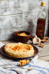 hummus of chickpeas, tahini paste and with paprika in a clay pla