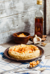 hummus of chickpeas, tahini paste and with paprika in a clay pla