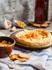 hummus of chickpeas, tahini paste and with paprika in a clay pla