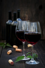 Glass of red wine on old wooden table