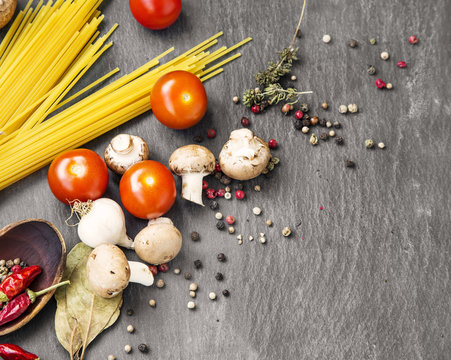 Italian meal ingredients with pasta,spices,tomatoes and mushroom