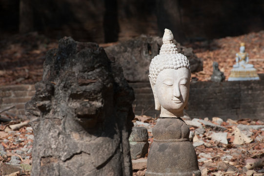 Ancient outdoor broken Buddhas in Wat Umong Suan Puthatham,Chieng Mai Province,Thailand.