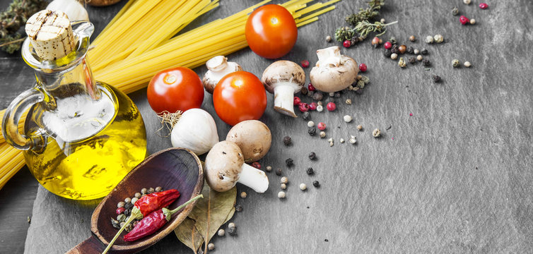 Italian meal ingredients with pasta,spices,tomatoes,olive oil an