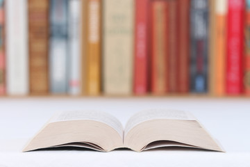 close-up of a book on a table with a library in the background