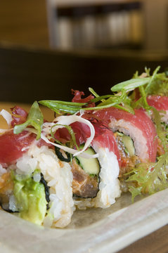 Ahi tuna sushi roll, avocado, and micro green garnish.
