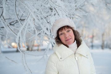 Beautiful woman 50 years old walking on the snowy city of St. Petersburg