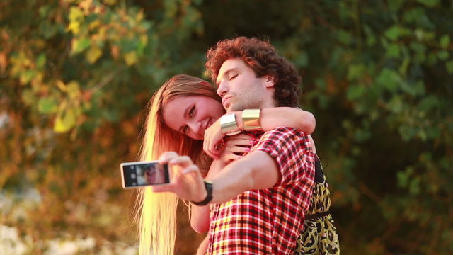Cute young couple taking selfies and laughing