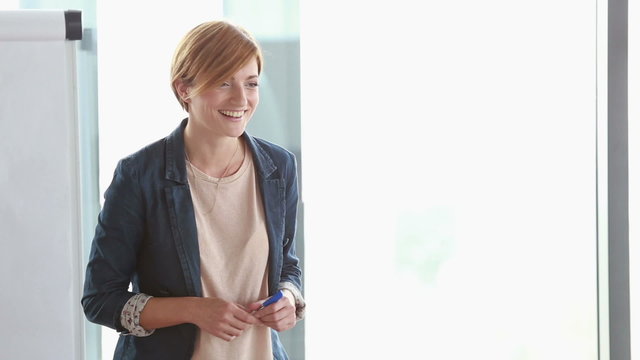 Smiling businesswoman giving presentation