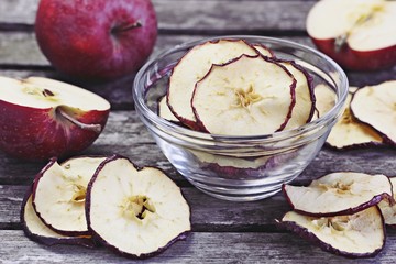 Sun dried apple chips on a rustic wooden table.Healthy snack.Selective focus 