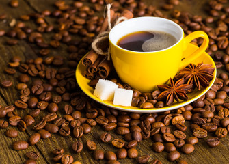 Coffee cup and saucer on a wooden table. Dark background, coffee