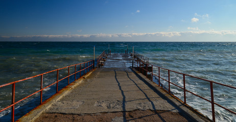 Old destroyed pier at sea