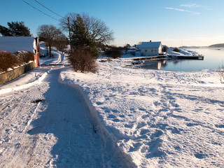 Snowy road by the coast at winter in Kristiansand, Southern Norway
