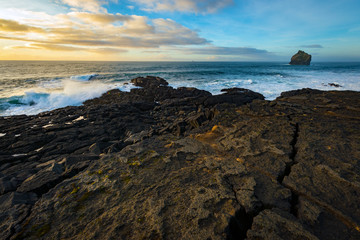 Coast of Iceland, black rocks and sea