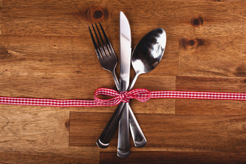 Valentines day set with silverware on wood background